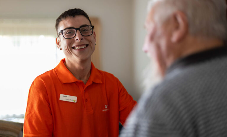 Helping Hand worker smiling at his elderly client